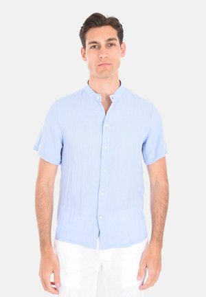 Camicetta azzurro chiaro a maniche corte realizzata in un tessuto texturizzato, con colletto a fascia e chiusura frontale con bottone.