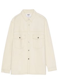 Beige denimskjorta med knäppning fram, två bröstfickor och krage. Stygn syns subtilt längs sömmarna och fickkanterna.