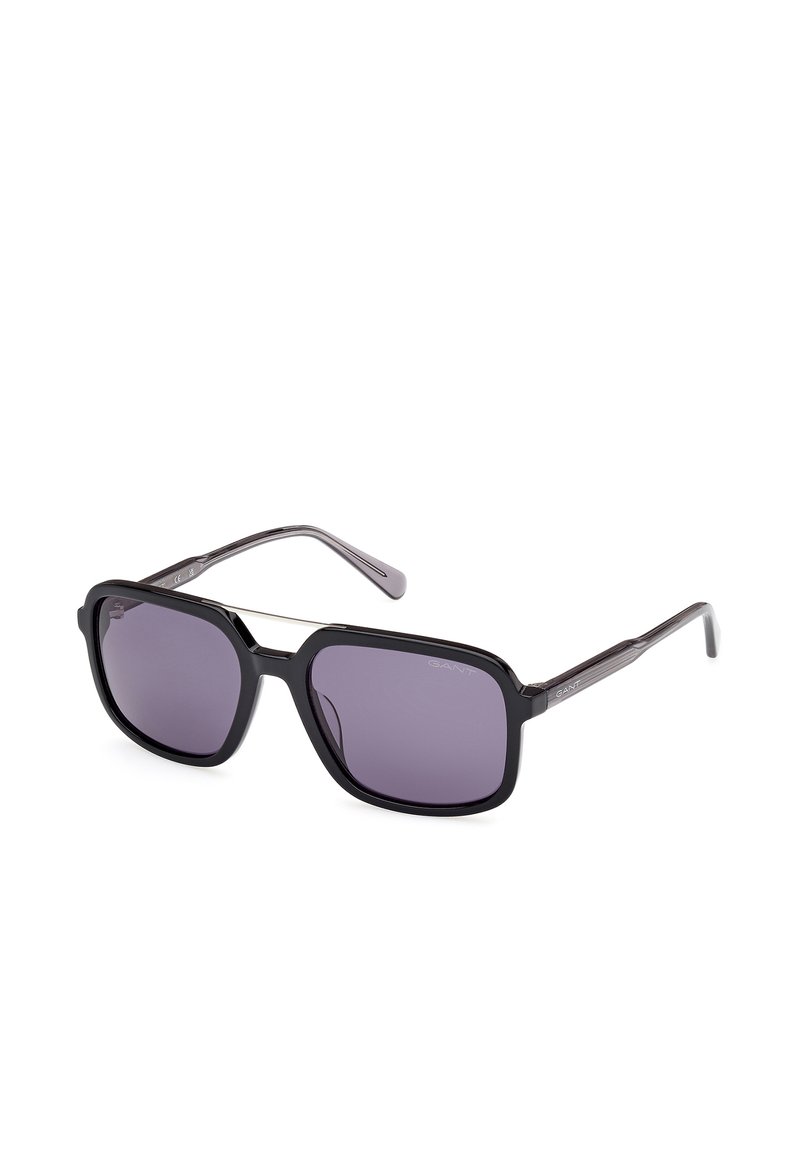 Ochelari de soare negri cu lentile dreptunghiulare și nuanță violet închis. Au un cadru elegant, brațe subțiri și detalii subtile cu logo pe laterale.