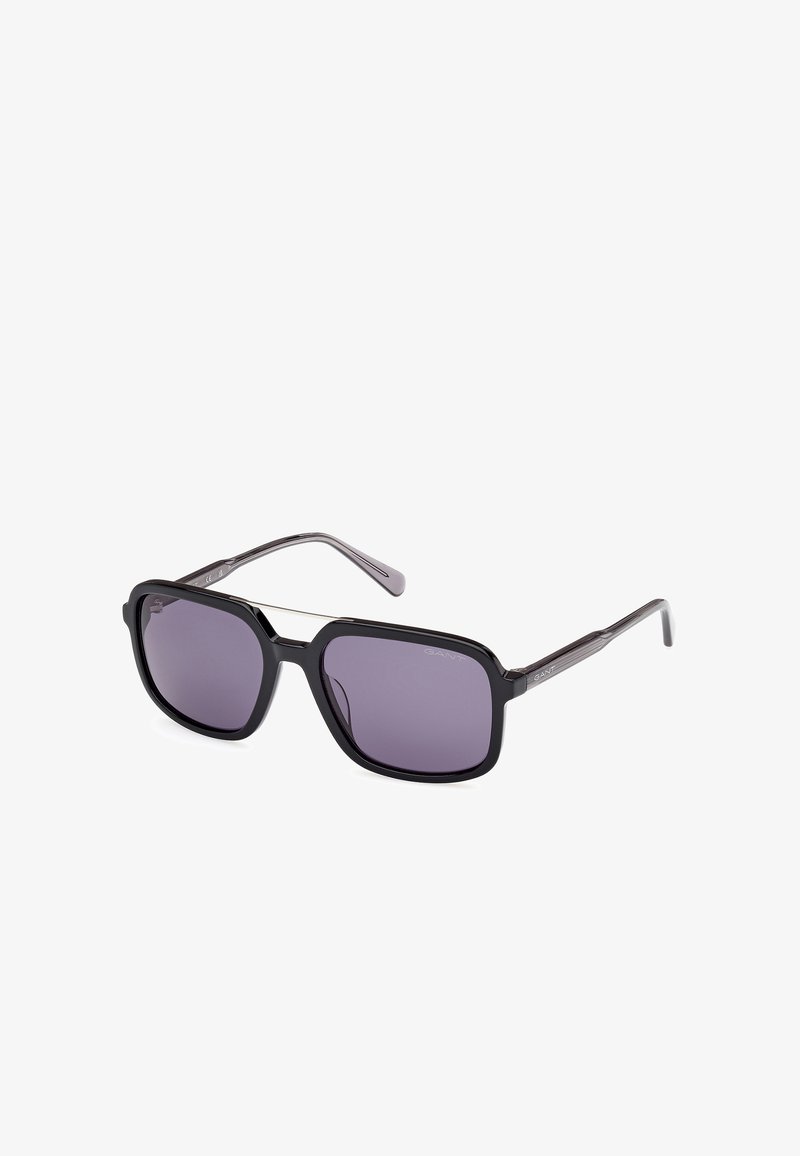 Black sunglasses with rectangular lenses and dark purple tint. Features a sleek frame, thin arms, and subtle logo detailing on the sides.