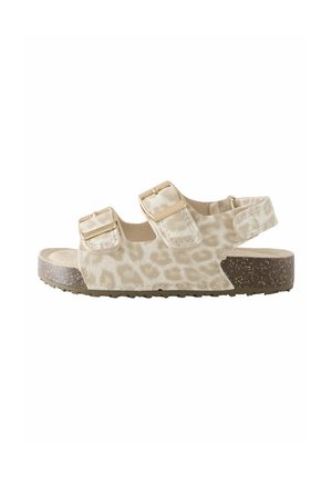 Sandale pour enfant beige avec deux brides à boucle réglables, bride arrière fermée et semelle marron texturée.