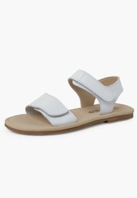 Sandales blanches avec deux sangles Velcro, design ouvert à l'avant, et une semelle texturée beige. Les sangles ont une finition lisse.