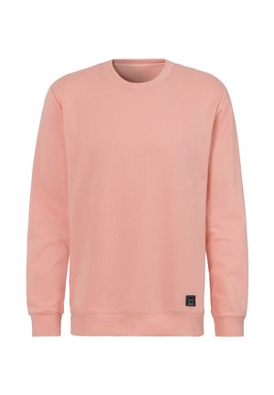 Plain light pink crewneck sweatshirt with long sleeves and a small black logo patch near the bottom hem
