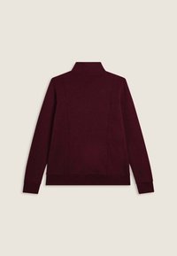Sweat-shirt bordeaux avec un col haut, des manches longues et des poignets côtelés. Texture lisse avec de subtils détails de coutures à l'arrière.