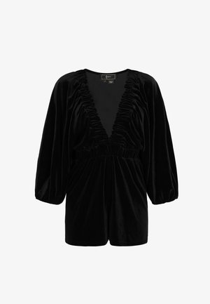 Tuta corta in velluto nero con scollo a V profondo e dettagli arricciati sullo scollo e sulle maniche. Presenta una vita elastica e pantaloncini corti.