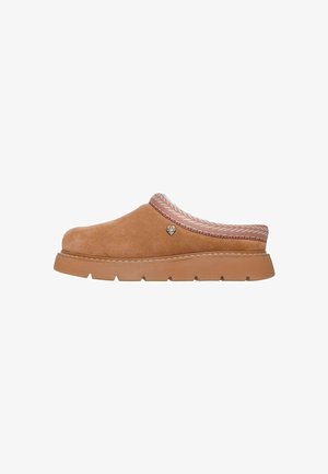 Brown suede slip-on clog with thick rubber sole and patterned fabric trim around the heel opening, featuring a small heart-shaped emblem.