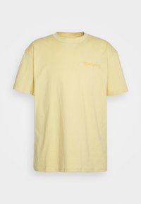 Yellow cotton t-shirt with short sleeves and a crew neck. Features a small orange logo on the left chest area. Straight hem design.
