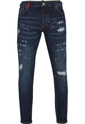 Tamno plave traperice s izlizanim mrljama, detaljima boje bijele i plave boje te slim fit dizajnom. Sadržava zakovicu i zatvarač.