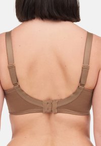 Ruskea puuvillainen rintaliivi, jossa on säädettävät olkaimet, hakasuljenta ja sileä pinta, jossa on saumaton takasuunnittelu.