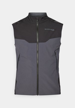 Sleeveless vest in black and dark gray fabric with a front zipper, side pockets, and textured shoulder accents. Features logo detail.