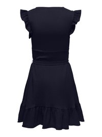 Robe noire sans manches avec des détails à volants aux épaules et un ourlet évasé et à volants, vue de dos.
