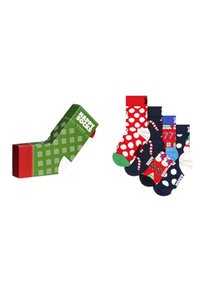 Boîte verte et rouge à motifs étiquetée "Happy Socks" à côté de quatre paires de chaussettes à pois et à motifs festifs dans différentes couleurs.