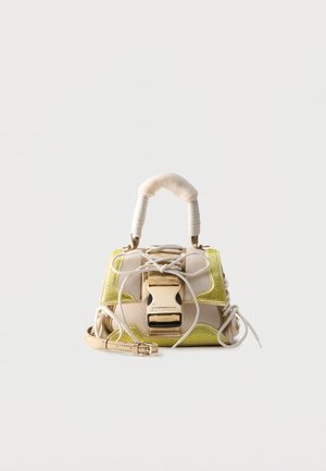 Small beige and yellow handbag with padded handle, front buckle clasp, and decorative laces on smooth, light background.
