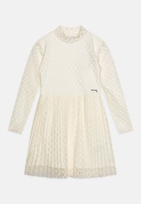 Dlouhý rukáv šatů z krémové krajky, s diamantovým vzorem, s polo-stojáčkem a rozšířenou sukní. Obsahuje malý kovový detail blízko lemu.