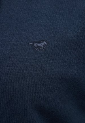 Tumši zils Adījuma audums ar mazu izšūtu žokļveida zirgu tādā pašā zilā diegā, kas centrēts uz materiāla.