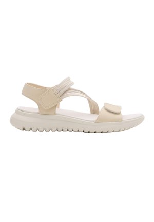 Sandalia beige con punta abierta, suela acolchada, tiras ajustables de velcro sobre los dedos y alrededor del tobillo, y suela exterior con estrías para agarre.