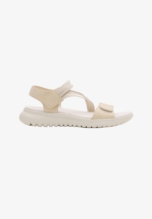 Sandalia beige con punta abierta, suela acolchada, tiras ajustables de velcro sobre los dedos y alrededor del tobillo, y suela exterior con estrías para agarre.