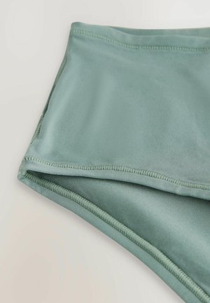 Hellgrün Badebekleidung aus einem glatten, elastischen Material mit flachen Nähten und einem einfachen Design, das eine einheitliche Farbe und eine weiche Textur betont.