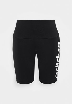 Shorts de sport noirs taille haute avec "adidas" imprimé verticalement en blanc sur la jambe gauche, sur fond uni.