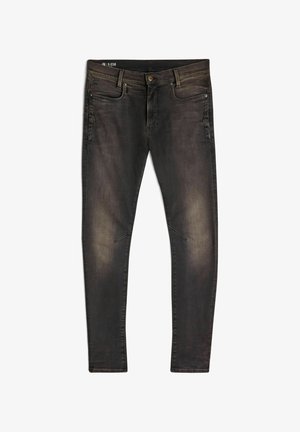 Jeans pretos desbotados de corte slim, com botão frontal, passantes para cinto e design de cinco bolsos, dispostos em plano sobre um fundo branco.