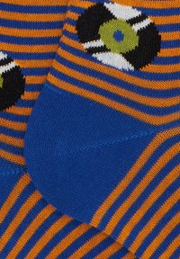 Calze a righe arancioni e blu con un motivo a pallone da calcio. Realizzate in tessuto lavorato a maglia con zona punta e tallone rinforzate.