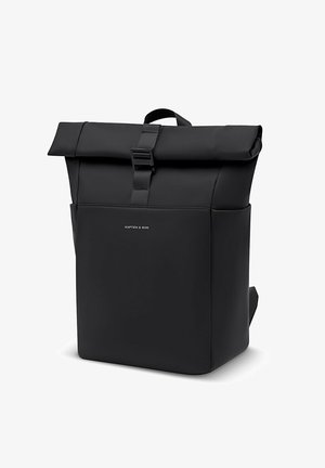 Black roll-top backpack with a front buckle and a small "Kapten & Son" logo on the front pocket, standing upright on a white background.