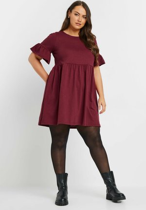 Maroon short-sleeve dress with ruffled sleeves, gathered waist, and flared skirt. Paired with black ankle boots and opaque tights.