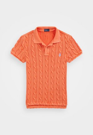 Oranž villane polo särk, millel on nööride muster, lühikesed varrukad ja pehme krae. Vasakul rinnal väike sinine logo.