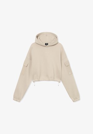 Beige cropped hoodie gemaakt van zachte stof; heeft een drawstring zoom, een oversized capuchon en twee opgestikte zakken op de mouwen.