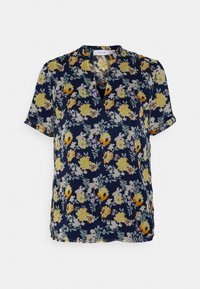 Blusa de manga curta azul-marinho com decote em V, apresentando um padrão floral em amarelo, branco e roxo. Tecido suave com um corte solto e fendas laterais.