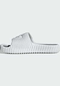 Vita sandaler i vitt med ribbat mönster, öppen tå-design och en vågmönstrad ovandel. Ribbad sula för bättre grepp.