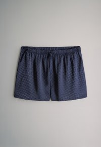 Granatowe spodenki w białe kropki, z elastycznym pasem i luźnym krojem. Wykonane z lekkiego materiału dla komfortu.