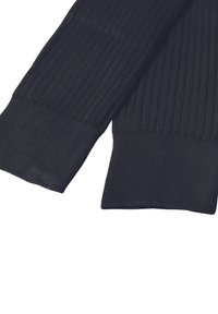 Calze riscaldanti nere in tessuto a coste con una finitura texture e ampie maniche elastiche. Il design presenta linee verticali per un dettaglio aggiuntivo.