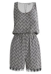 Combinaison sans manches à motif zébré noir et blanc, avec taille élastique et bordure en dentelle noire à l'ourlet du short.