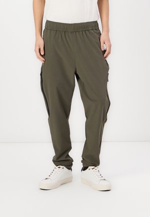 Olive green, lightweight cargo pants with an elastic waistband, side pockets, and black zipper accents. Smooth texture, tapered fit.