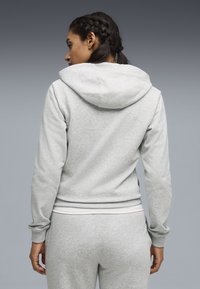 Γκρι φούτερ με κουκούλα και απαλή υφή, με ριμπ μανσέτες. Διαθέτει τσέπη τύπου καγκουρό και κουκούλα με ρυθμιζόμενο κορδόνι.