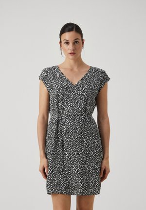 Black dress with white floral pattern, V-neck, short sleeves, gathered waist detail, and above-knee length. Smooth fabric texture.