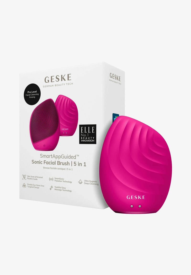 Lyserød silikone Sonic ansigtsbørste med struktureret overflade, ergonomisk form og en æske, der viser produktdetaljer og branding.