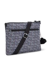 Borsa a spalla a fantasia bianca e nera realizzata in tessuto con una superficie liscia, dotata di chiusura con zip, tracolla regolabile e buffo pom-pom decorativo.