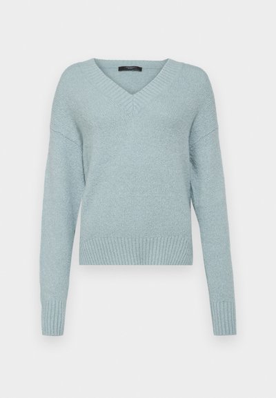 Vaaleansininen v-aukkoinen neuletakki, jossa on pitkät hihat sekä joustavat hihansuut ja helma. Pehmeä rakenne, hiukan löysä istuvuus ja minimalistinen muotoilu.