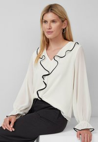 Off-White Bluse mit gerafftem schwarzen Saum am Kragen, langen Ärmeln mit elastischen Bündchen und einem lockeren Schnitt.