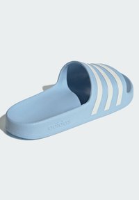 Light blue slide sandal made of textured material, featuring three white stripes on the upper and embossed branding on the side.