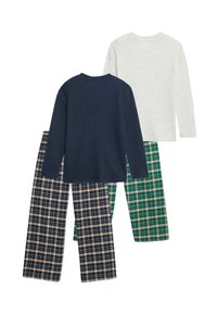 Trzy zestawy odzieży domowej: granatowa prążkowana bluzka z długim rękawem, jasnoszara bluzka oraz spodnie w zieloną kratę i granatową kratę z beżowymi akcentami.
