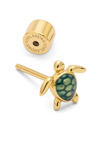 Pendiente en forma de tortuga de color dorado con una concha verde con patrones, que presenta una textura lisa y un respaldo cilíndrico con el nombre de la marca grabado.