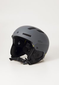 Gray ski helmet with vent holes, textured sides, and adjustable strap. Features branding and interior padding for comfort and protection.