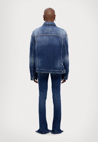 Denim jacket and flared jeans, both in blue with a faded finish. Jacket features a classic collar and buttoned cuffs, jeans with fringed hem.