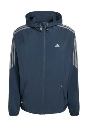 Laivastonsininen Adidas-huppari, jossa on etuvetoketju, joustavat hihansuut, vetoketjulliset sivutaskut ja kolme harmaata raitaa kummassakin hihassa.