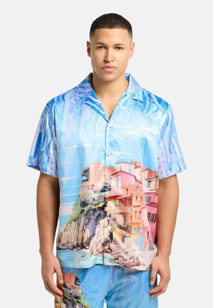Short-sleeve button-up shirt featuring a vibrant blue and pastel coastal print, with a smooth texture and a relaxed fit.