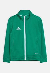 Grøn Adidas zip-jakke med hvid lynlås, sidelommer og Aeroready-logo på nederste højre side foran.