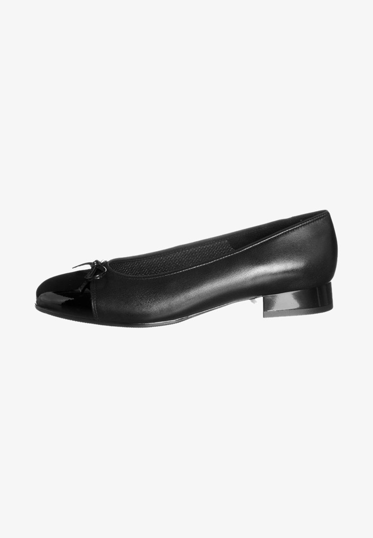 Ballerine plate en cuir noir avec embout brillant, petit détail nœud et talon bloc bas, vue de profil sur fond blanc.